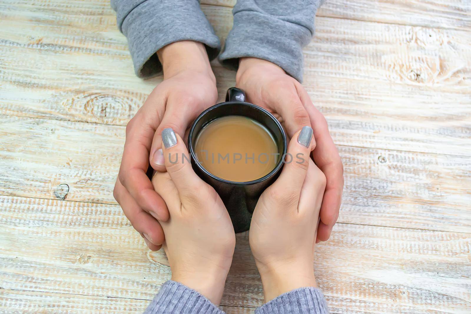 Concept of male and female hands, love and coffee