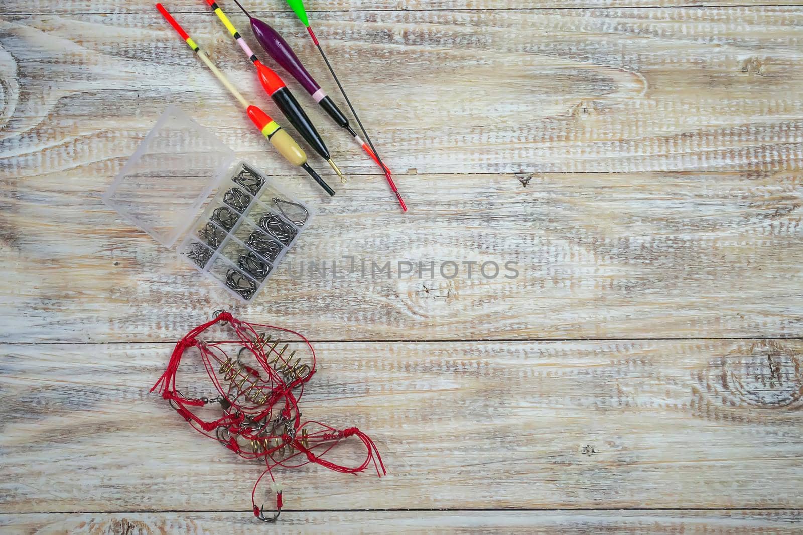 fishing tackles for anglers - swimmers, plummets and tools on wooden background. Selective focus