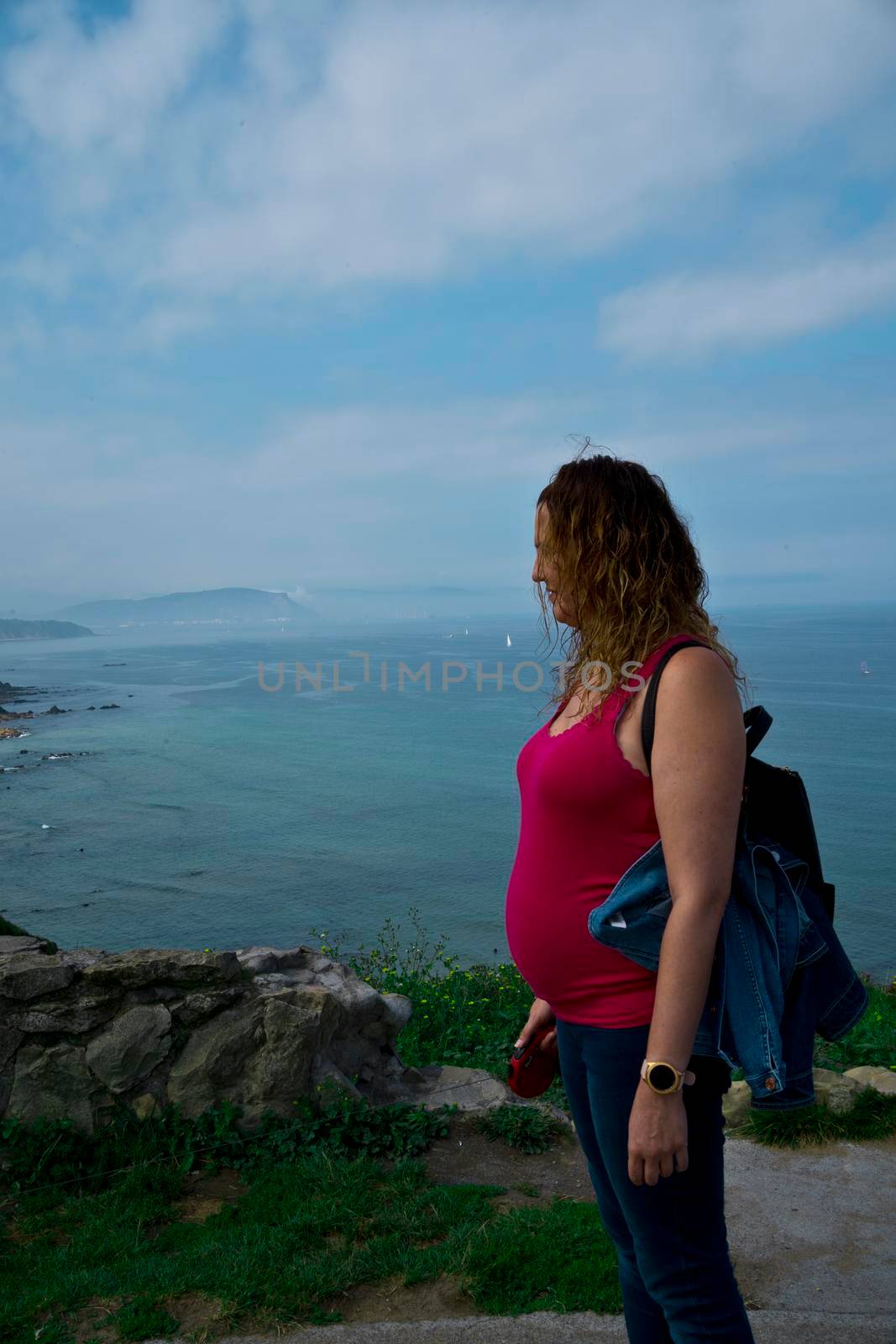 pregnant young woman posing by the sea by barcielaphoto