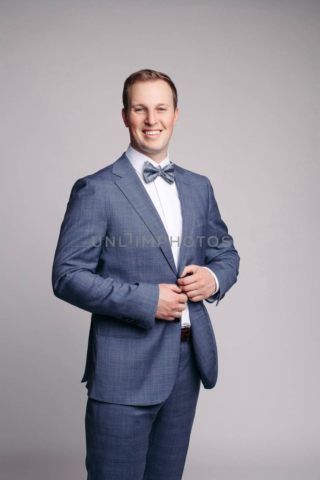 Portrait of handsome man in black suit by StudioLucky