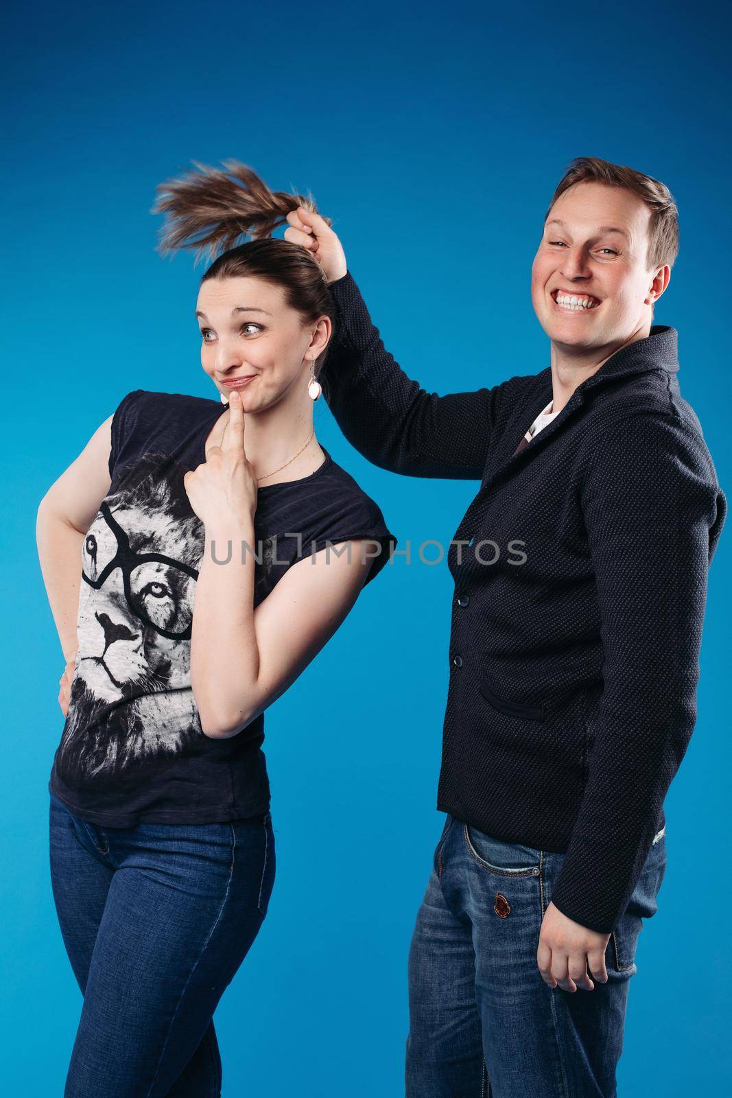 Charming caucasian male with short chestnut hair and a pretty woman rejoices together
