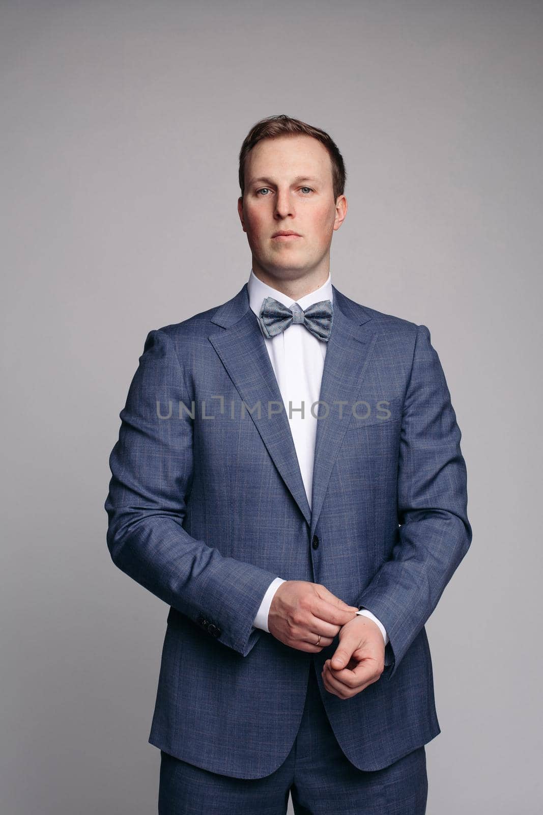 Portrait of handsome man in black suit by StudioLucky