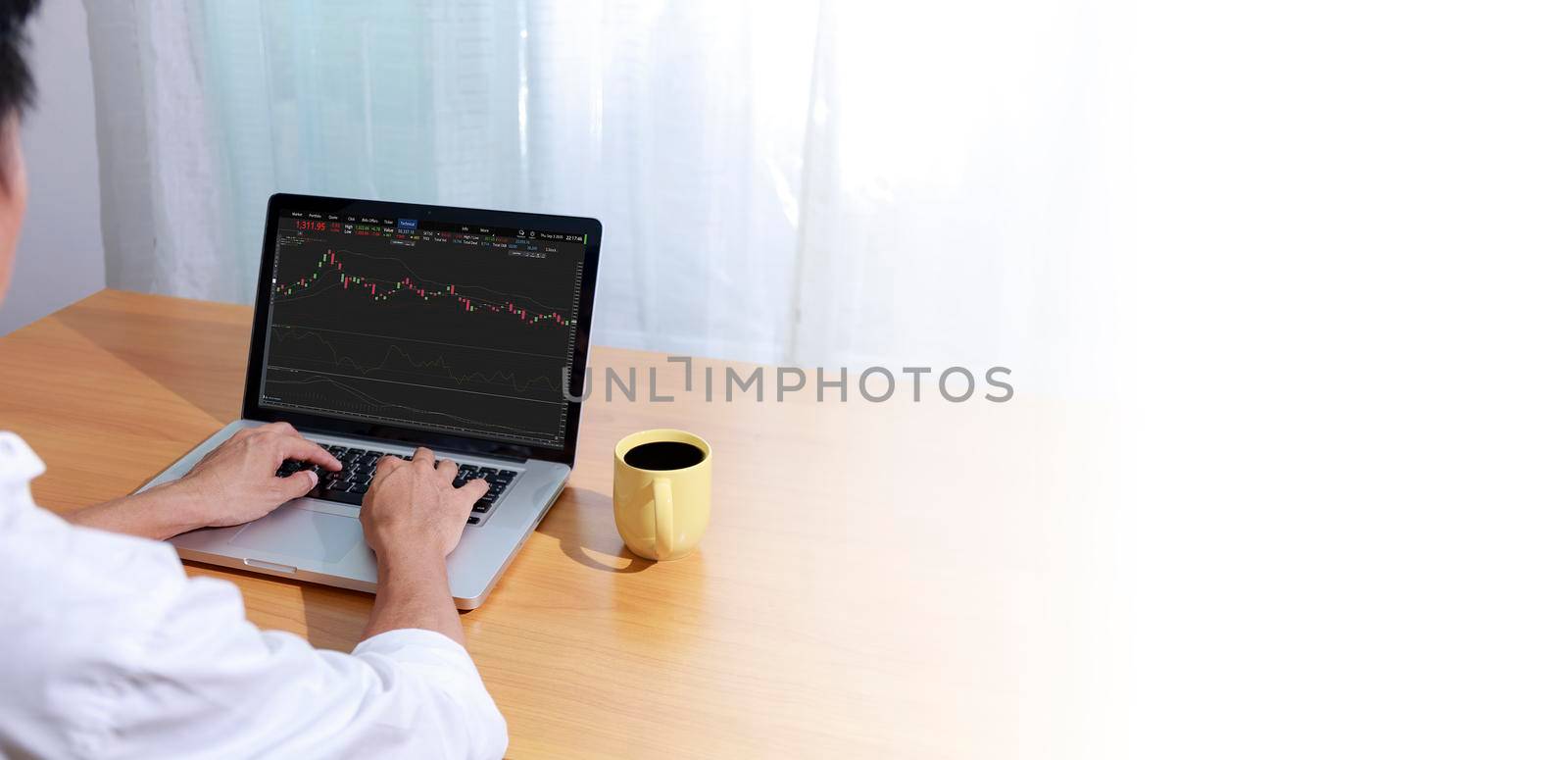 Business and technology concept Businessman hands with laptop and candlestick chart background. Businessman hands use computer network control trade buy and sell stock market with copy space. by Satrinekarn