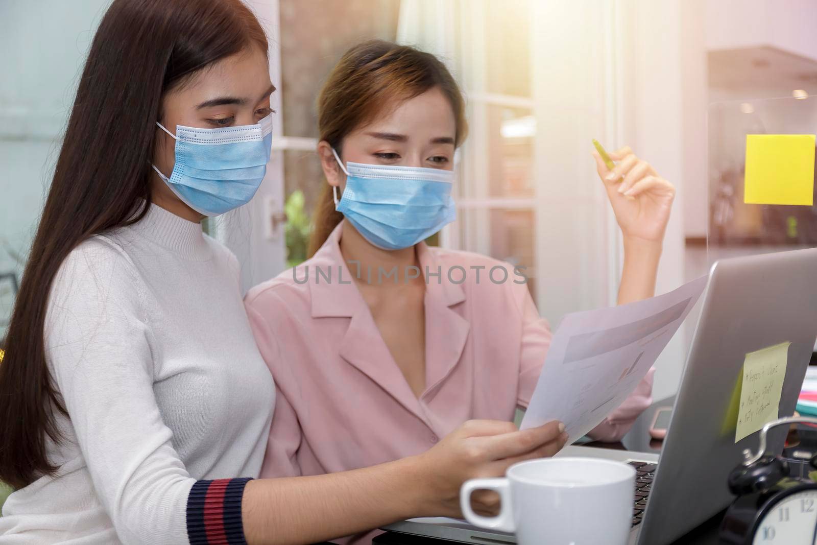 Asian Business Team Meeting Brainstorming Business start up working at Private Home Office social distancing among Coronavirus outbreak New generation business people meeting analysis work from laptop