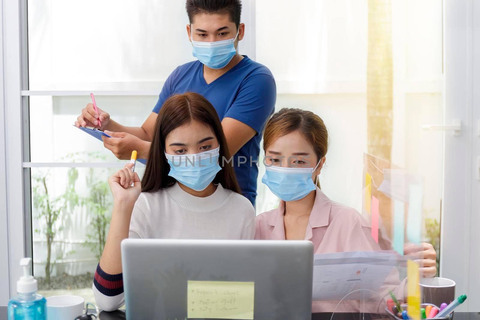 Asian Business Team Meeting Brainstorming Business start up working at Private Home Office social distancing among Coronavirus outbreak New generation business people meeting analysis work from laptop