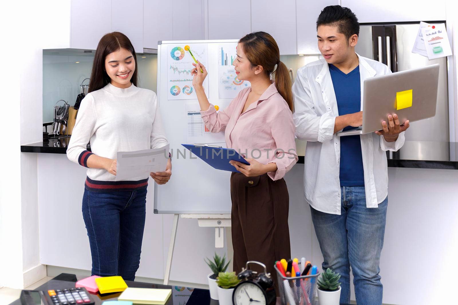 Business Team brainstorm meeting. Group of business people working at Private Home Office.Young business people working with laptop .Asian teamwork business people share idea with team at office