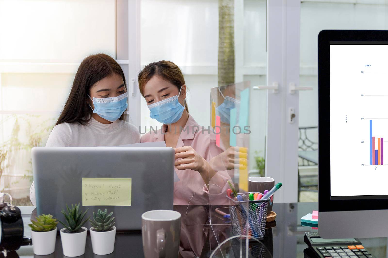 Asian Business Team Meeting Brainstorming Business start up working at Private Home Office social distancing among Coronavirus outbreak New generation business people meeting analysis work from laptop