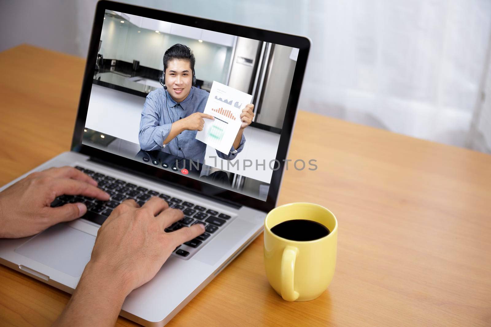 Businessman analysis financial chart with videoconference online meeting. Hand of businesswomen using laptop meeting with diverse colleagues. Covid-19 working from home.