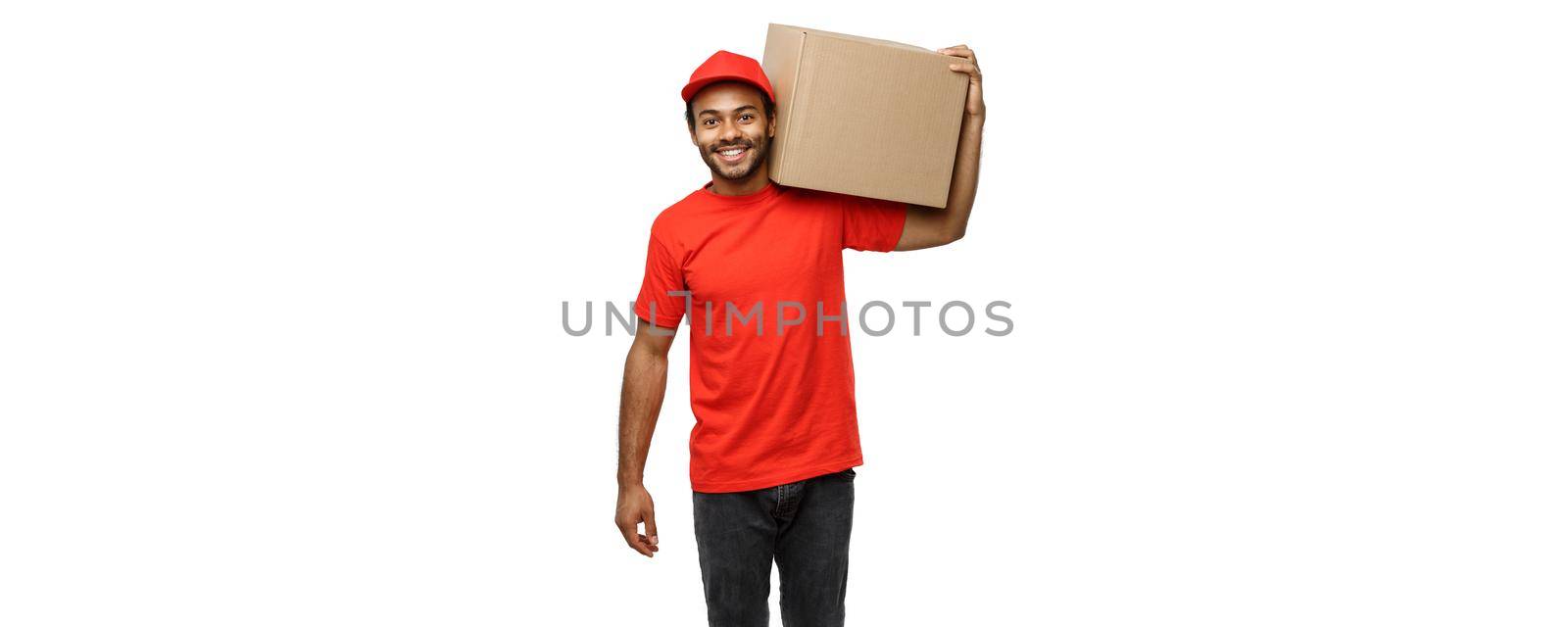 Delivery Concept - Portrait of Happy African American delivery man in red cloth holding a box package. Isolated on white studio Background. Copy Space by Benzoix