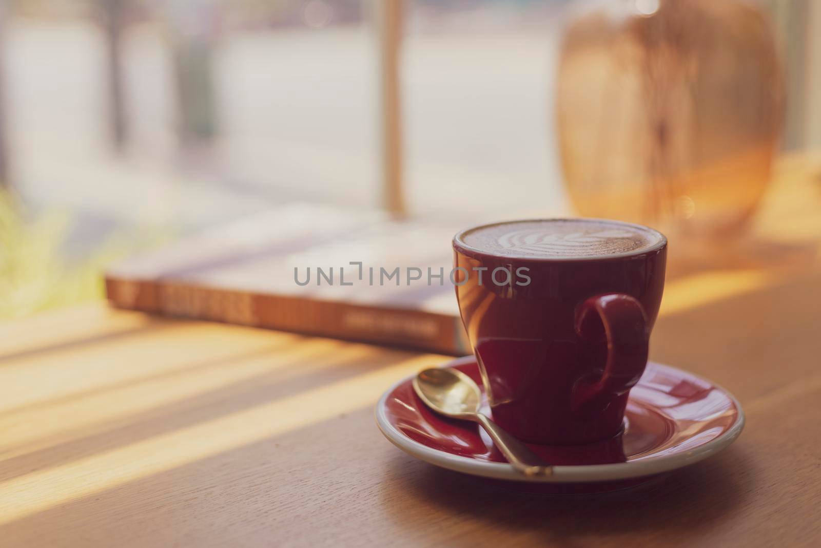 Close up hot art Latte, cappuccino Coffee in red cup on wooden table in Coffee shop blur background with bokeh image process with vintage style