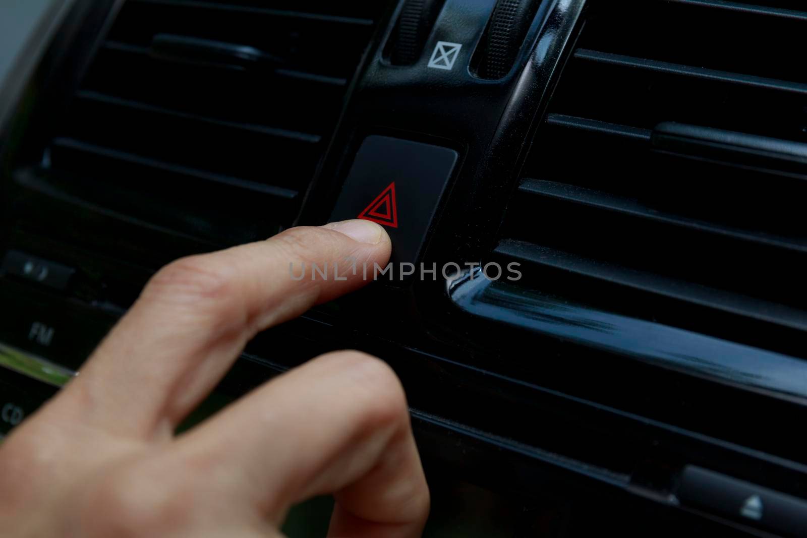 Close up hand press the emergency light in the car, Fingers press button.for open the contract emergency light in car. Emergency button press for open emergency light warning sign symbol out side car