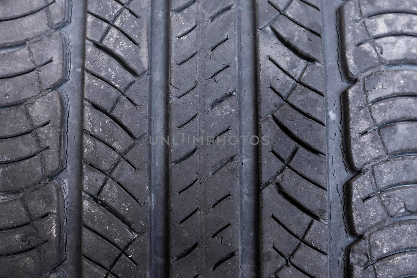 Close up macro old tire background , Non Slip rubber pad made from old tire. Old tire with damage. Automobile tire cover. Texture of rubber on wheels