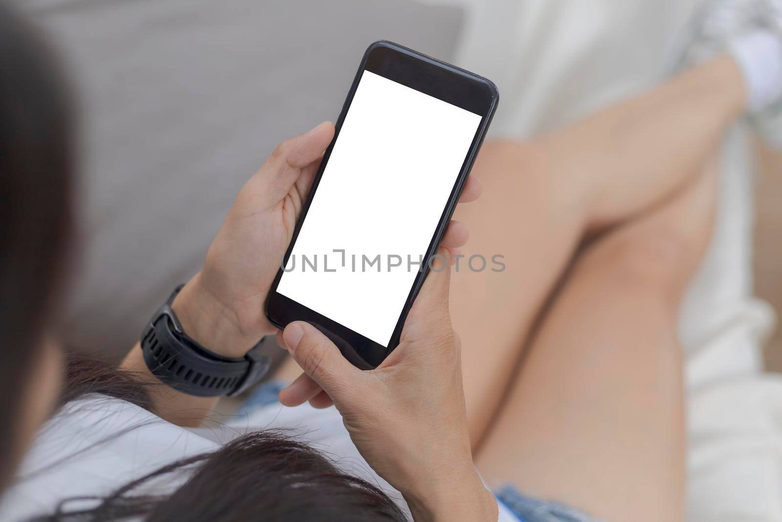Close up hands of woman using mobile phone, cell phone in coffee shop. Hands of women holding blank empty screen smart phone in cafe. Women relax with mobile phone sit in restaurant
