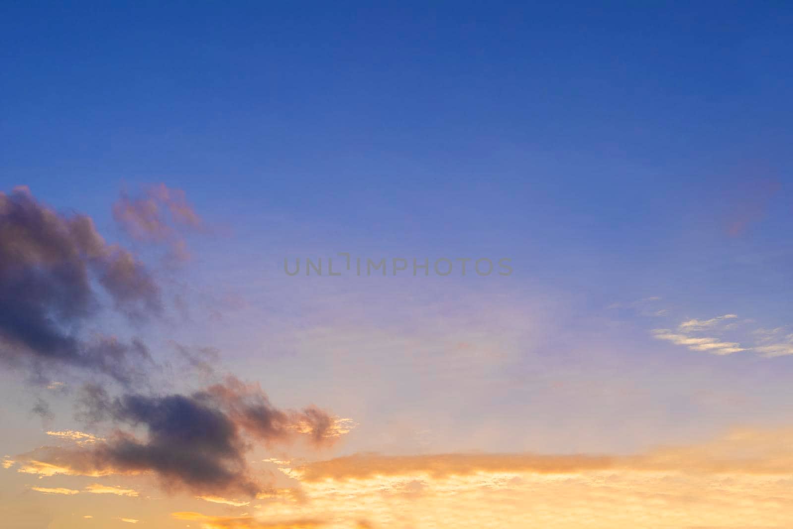 Beautiful morning clear sky background. Colorful yellow blue sky. Morning colorful clear blue sky background with soft white clouds sunrise or sunset.