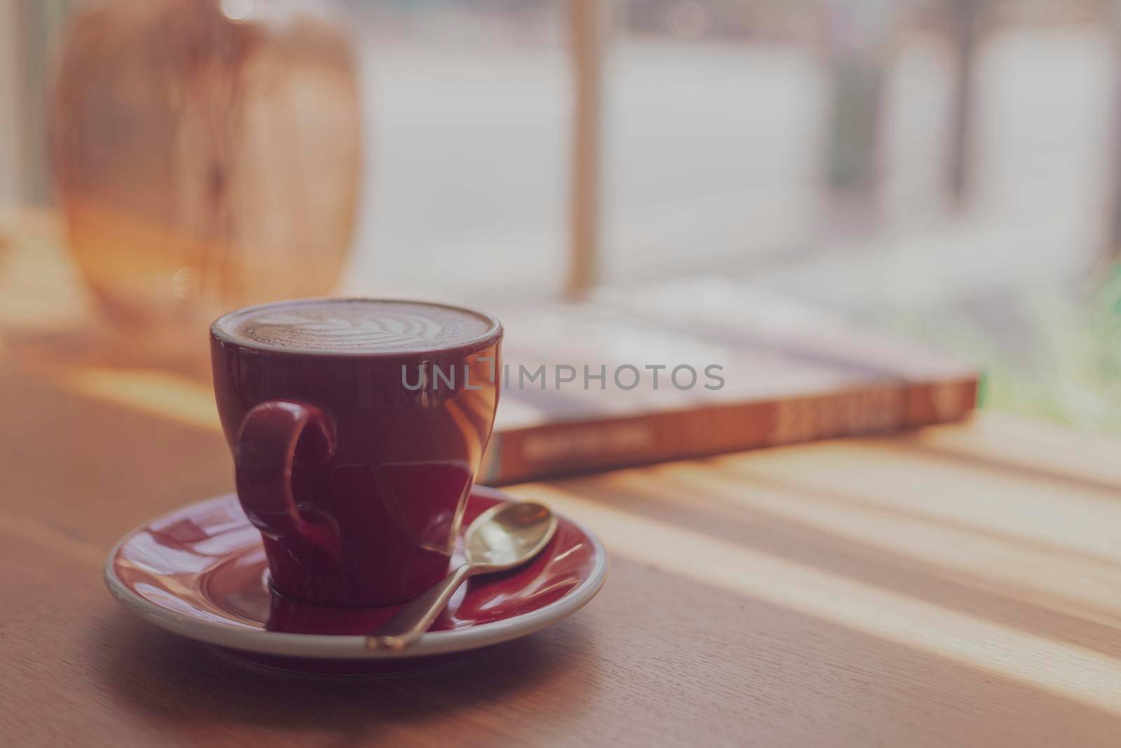 Close up hot art Latte, cappuccino Coffee in red cup on wooden table in Coffee shop blur background with bokeh image process with vintage style