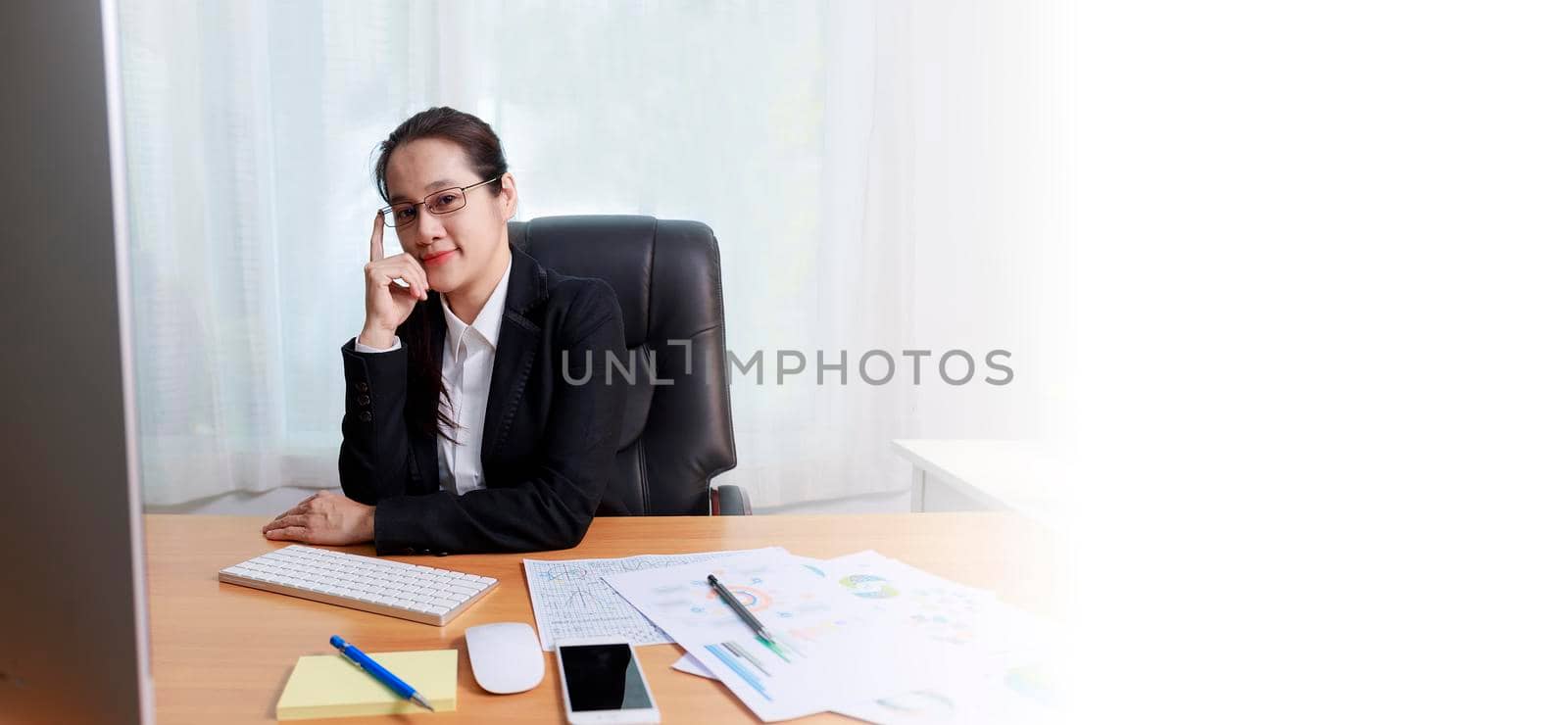 Business women smileing wear glasses sitting at office. business people using computer PC  at office. Business at home concept. With copy space banner.