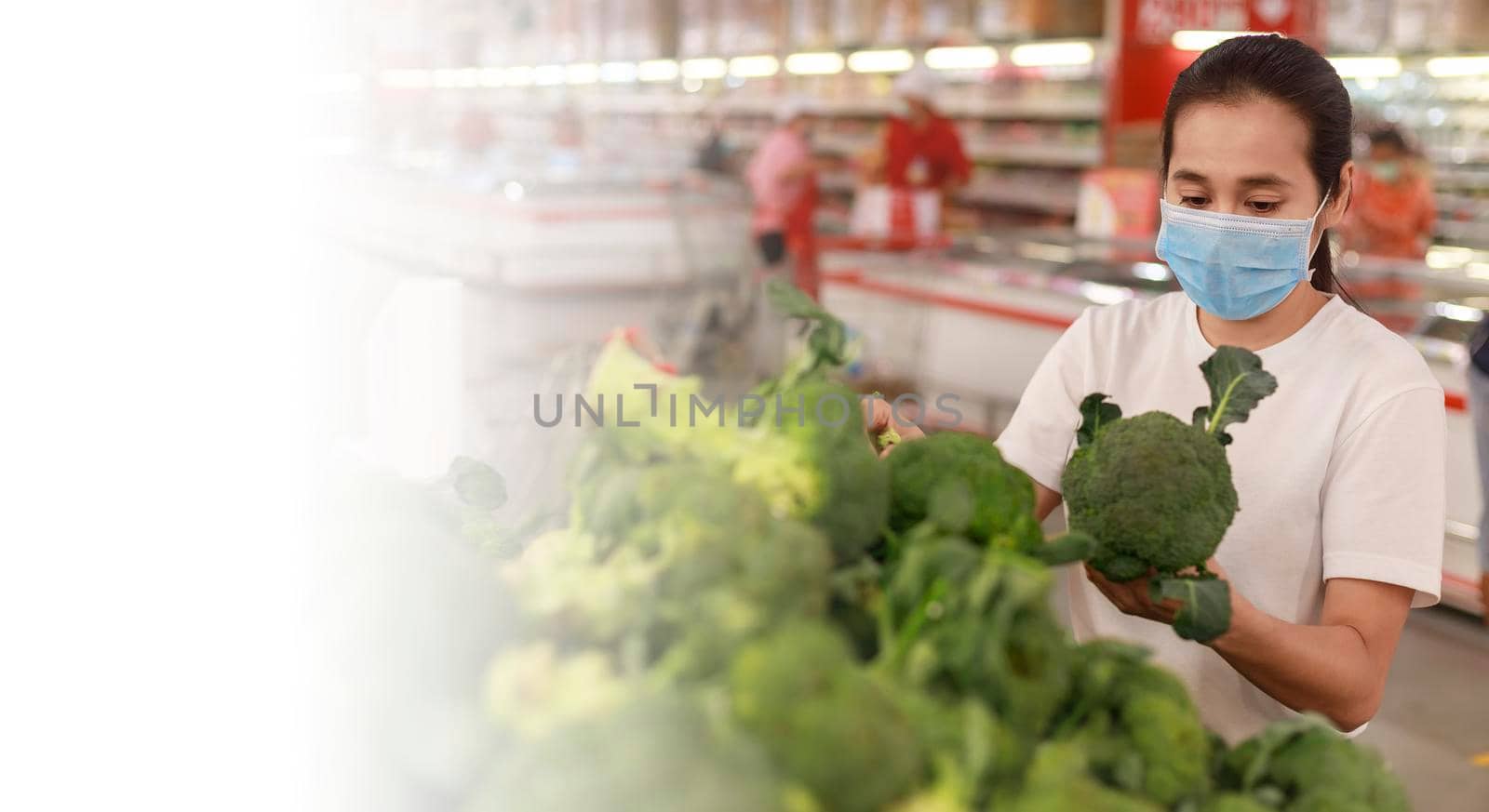Asian woman long hair wearing protective face mask  in supermarket department store. Female, looking grocery to buy  some fruit. New normal after covid-19. Family concept. with copy space banner