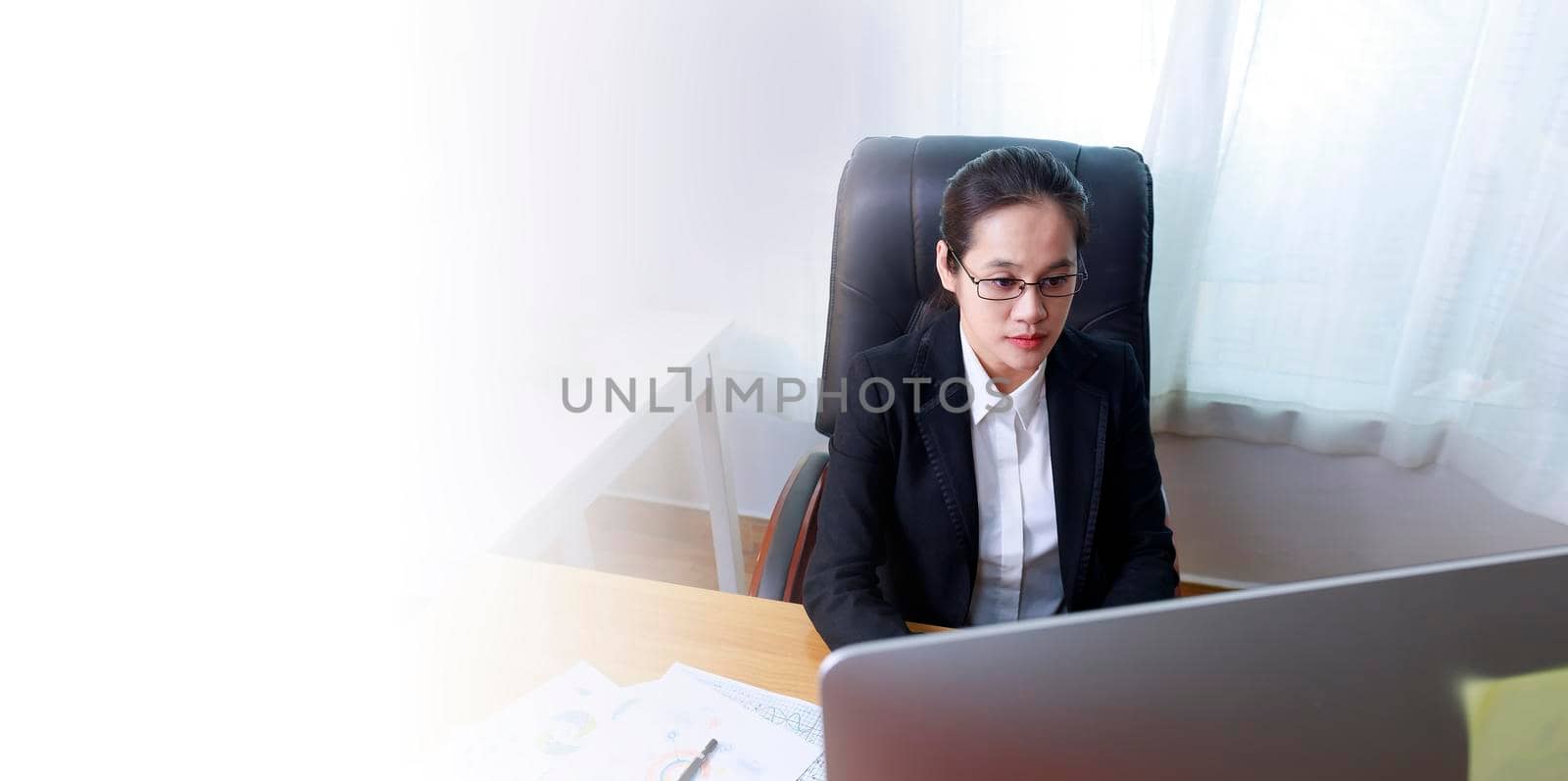 Asian business women analysis paper chart and typing keyboard insert data to computer at office. Business people working at home with internet. Banner