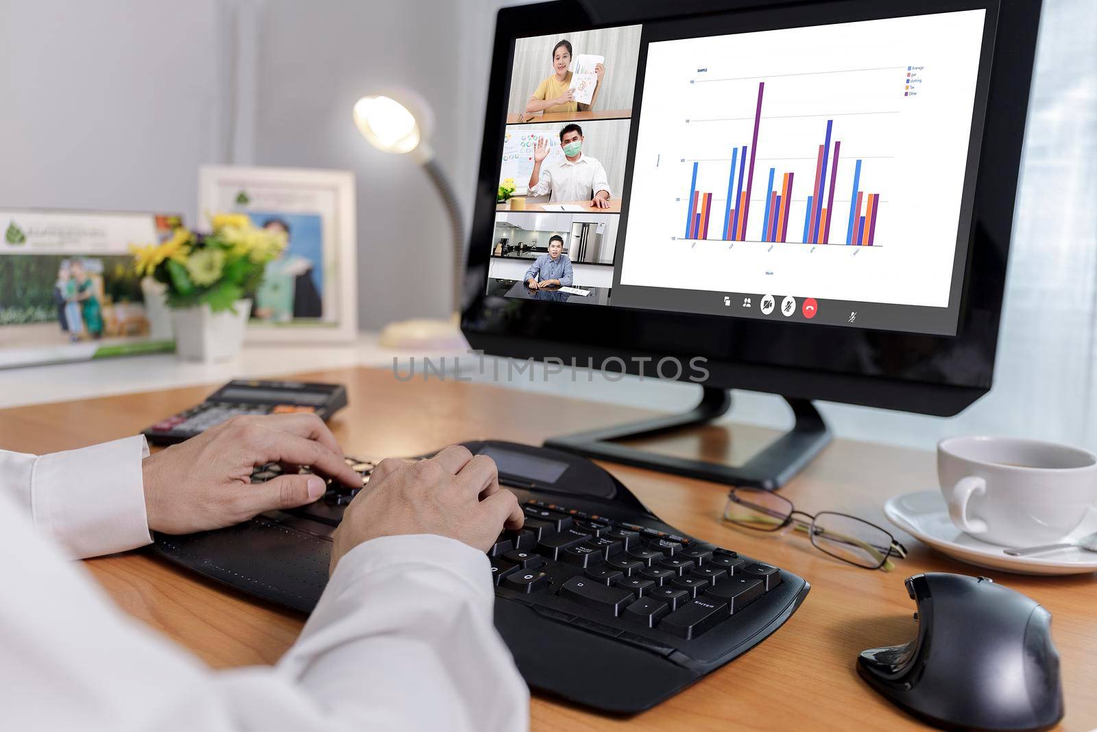 Hand of businessman and businesswoman analysis financial chart with videoconference online meeting. Hand of businesswomen using laptop meeting with diverse colleagues. Covid-19 working from home. 