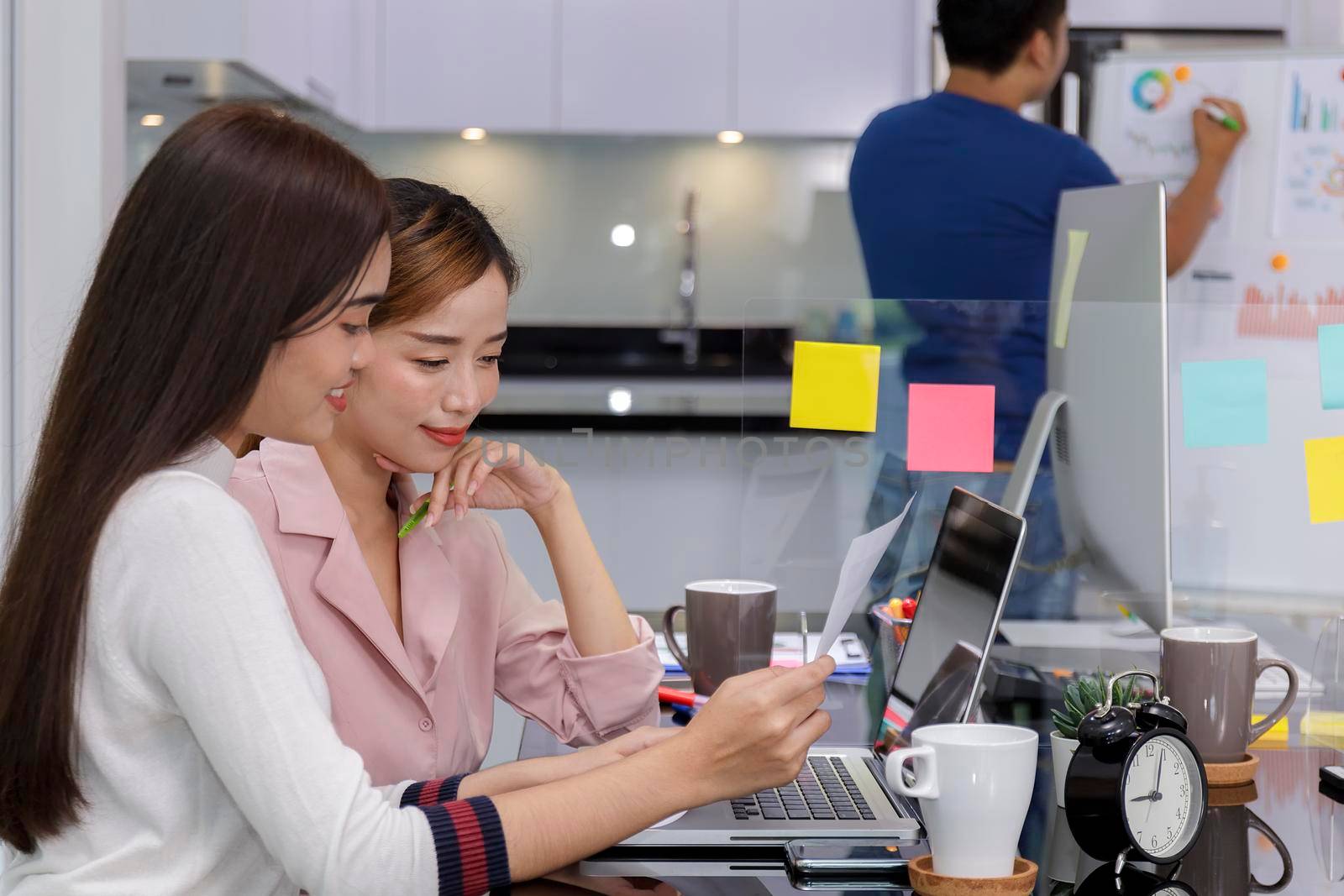 Asian Business Team Meeting Brainstorming Business start up working at Private Home Office social distancing among Coronavirus outbreak New generation business people meeting analysis work from laptop