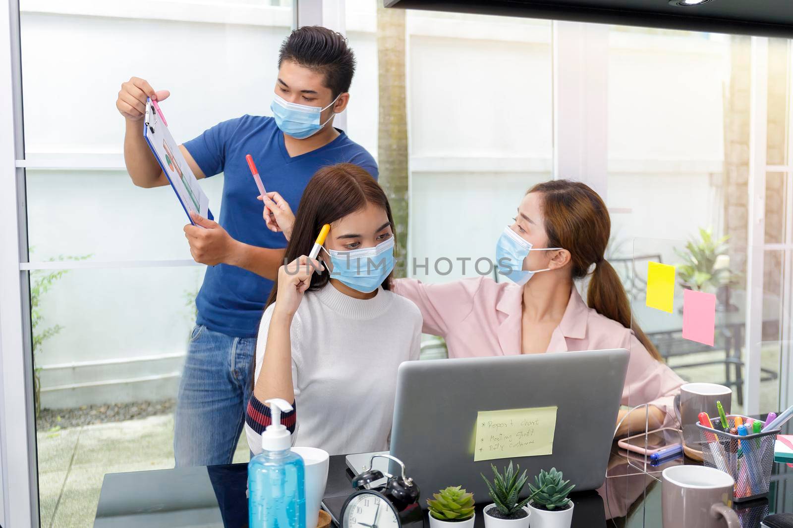 Asian Business Team Meeting Brainstorming Business start up working at Private Home Office social distancing among Coronavirus outbreak New generation business people meeting analysis work from laptop