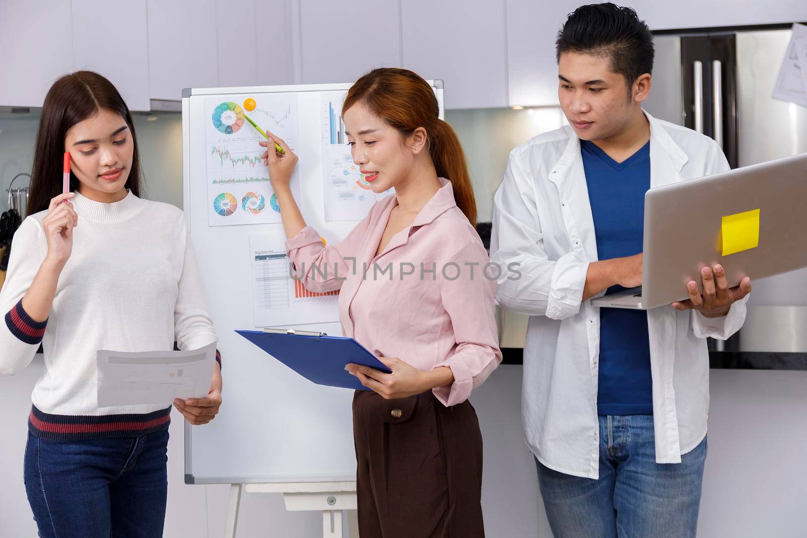 Business Team brainstorm meeting. Group of business people working at Private Home Office.Young business people working with laptop .Asian teamwork business people share idea with team at office
