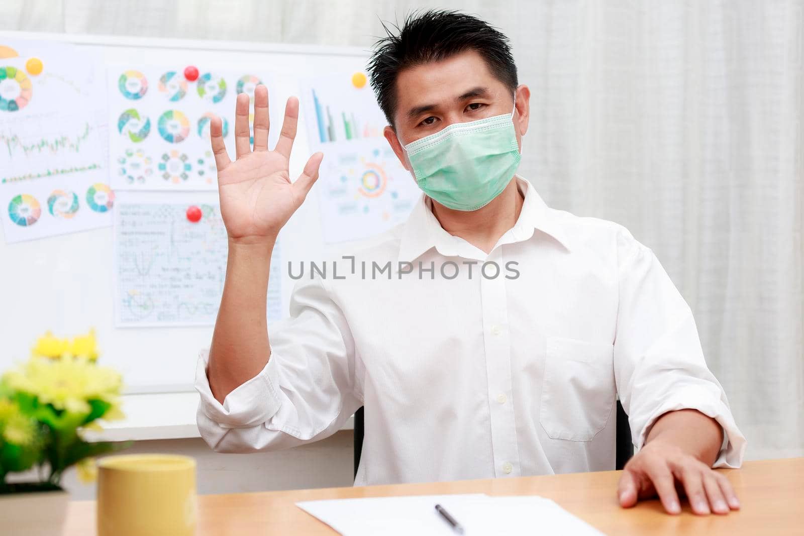 Asian business man using video call contact with friend, customers, partners from home. coronavirus outbreak crisis Business people wear protective face mask work from home with video conference.