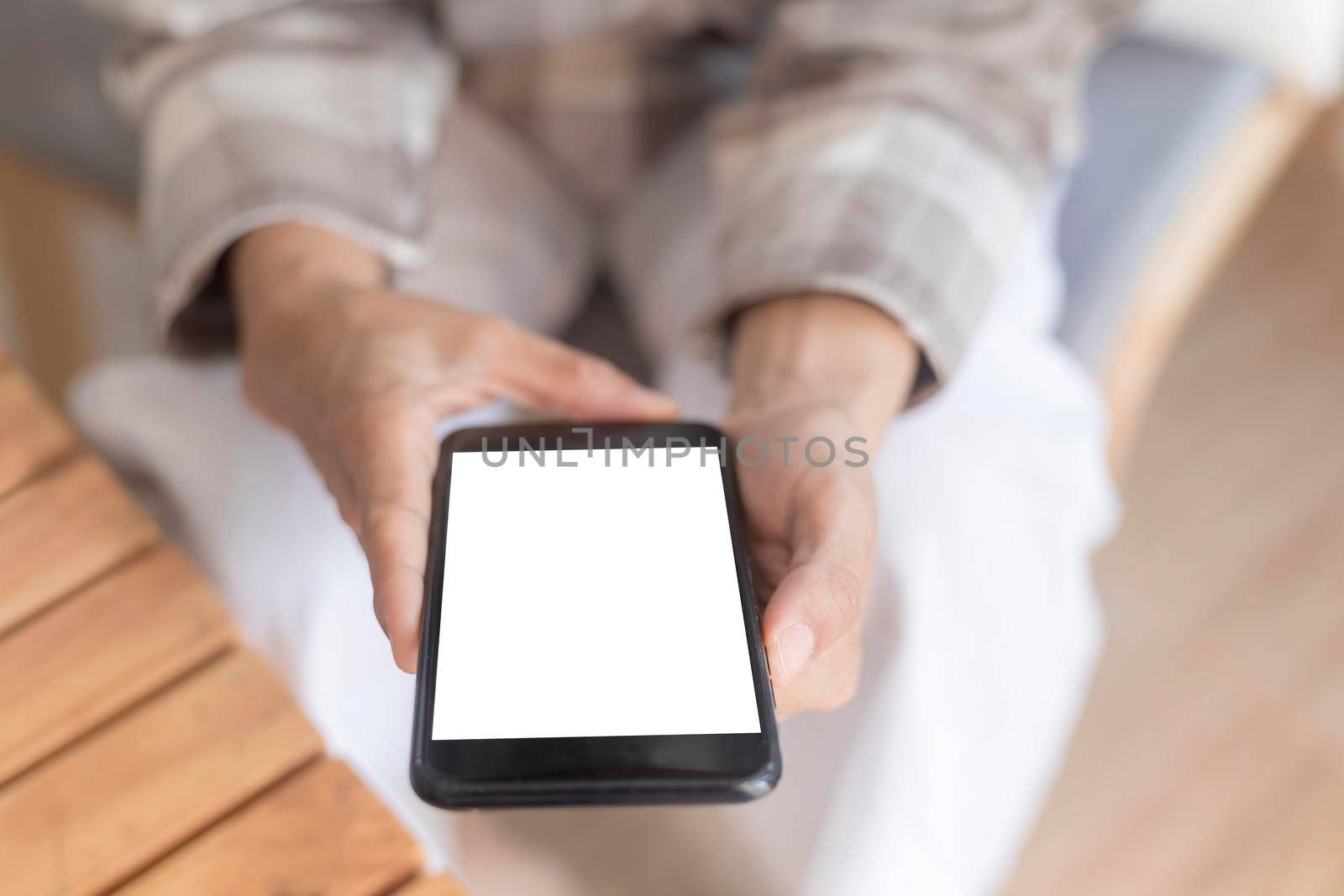 Close up women hands holding smartphone, mobile phone, cell phone with white blank screen for copy space. smart phone with blank screen on women hand soft focus selective phone. Technology lifestyle concept