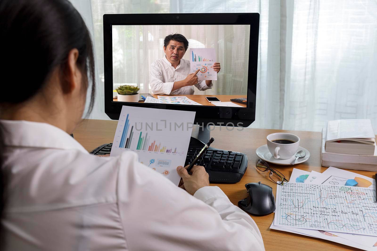 Business long distance video call, businessman and businesswoman analysis financial report using videoconference application for virtual communication, online meeting with videochat app. Covid-19 work from home.