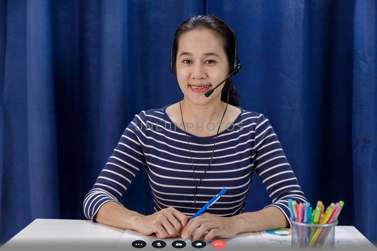 Screen of Businesswomen sit at desk and talk with business colleague via internet shows a graph with the dynamics of economic growth and analysis with team. Covid-19 work from home concept