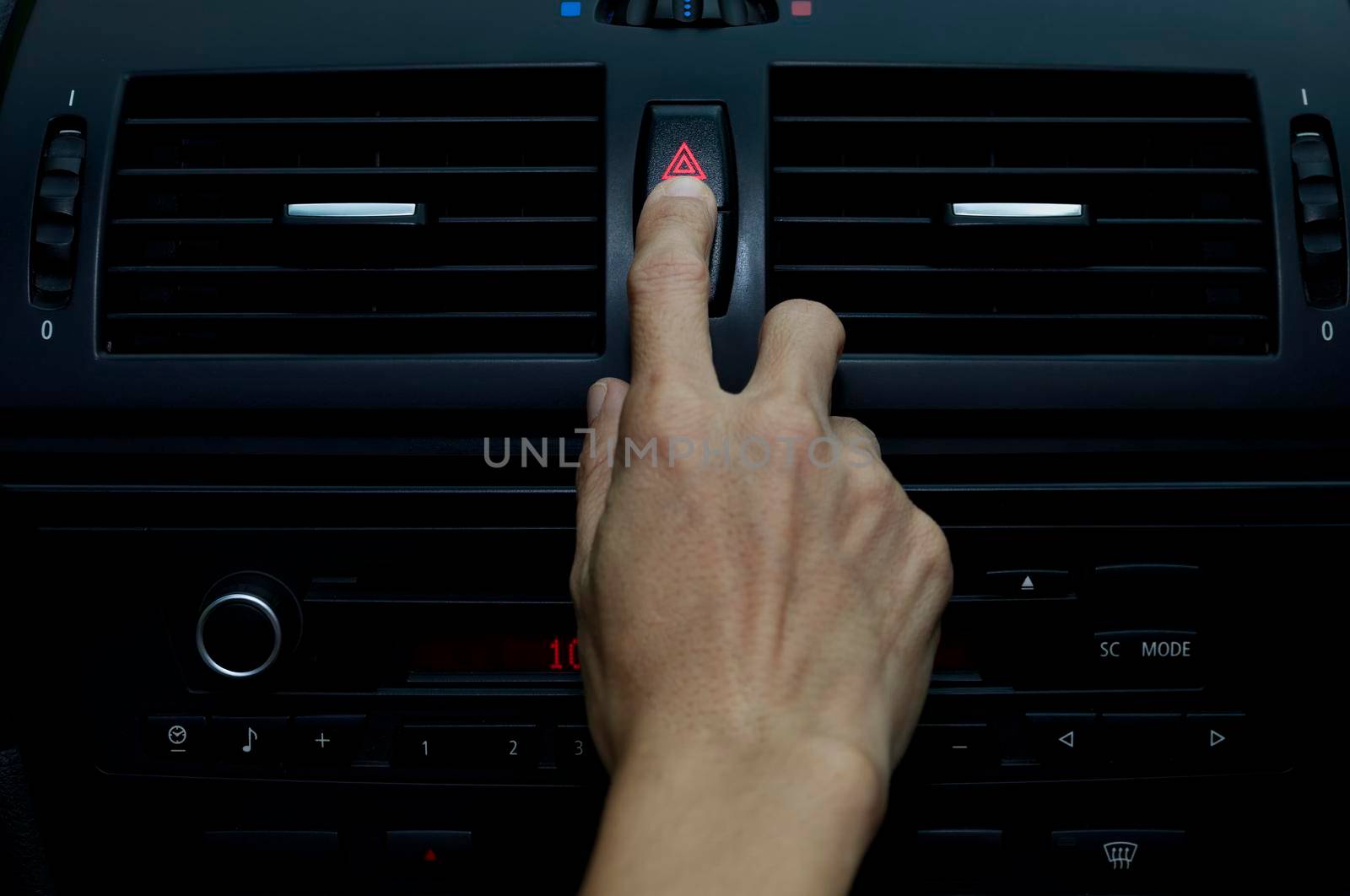 Close up hand press the emergency light in the car, Fingers press button.for open the contract emergency light in car. Emergency button press for open emergency light warning sign symbol out side car