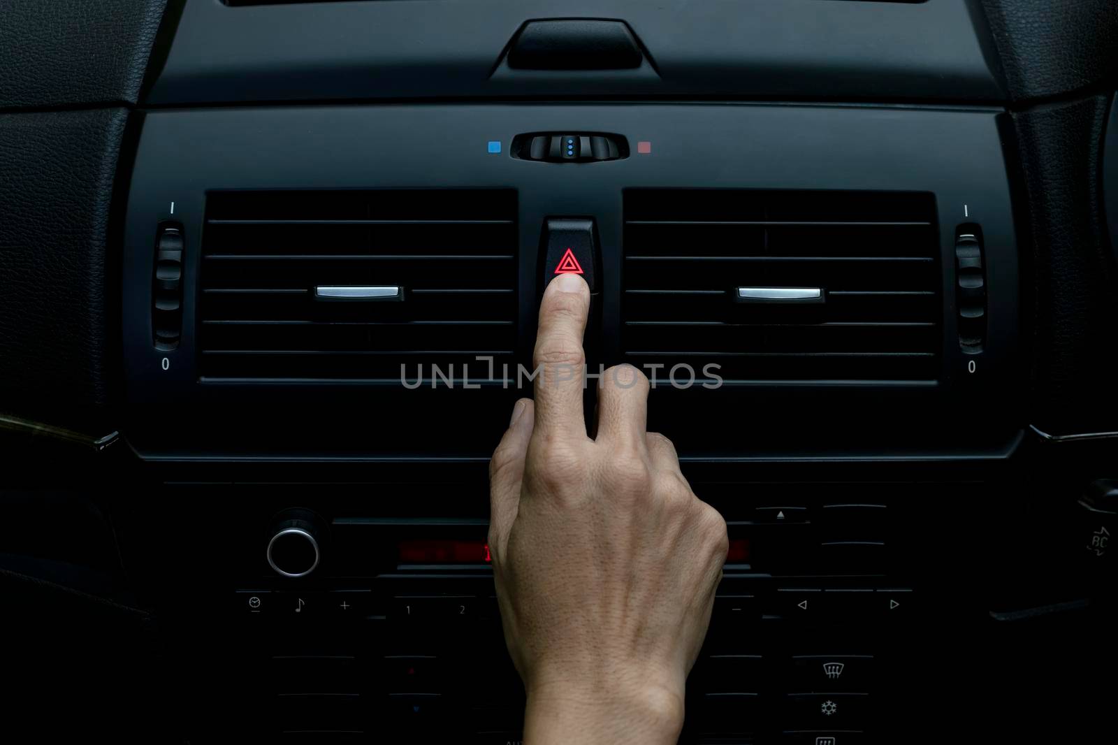 Close up hand press the emergency light in the car, Fingers press button.for open the contract emergency light in car. Emergency button press for open emergency light warning sign symbol out side car