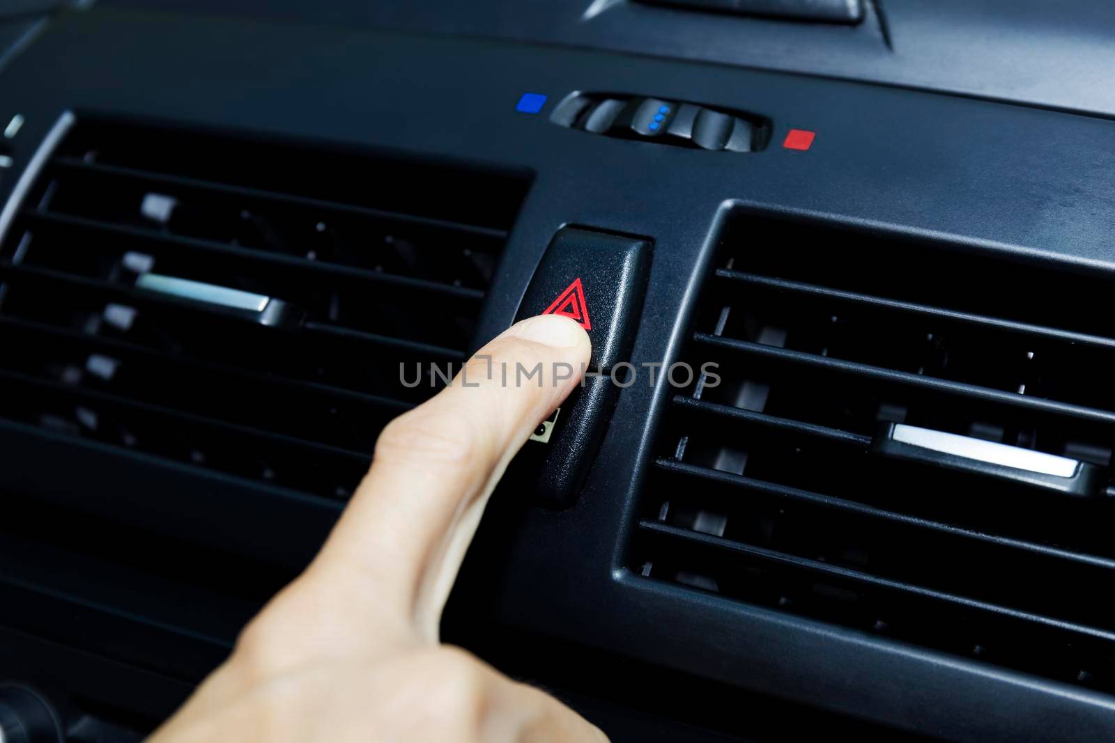 Close up hand press the emergency light in the car, Fingers press button.for open the contract emergency light in car. Emergency button press for open emergency light warning sign symbol out side car