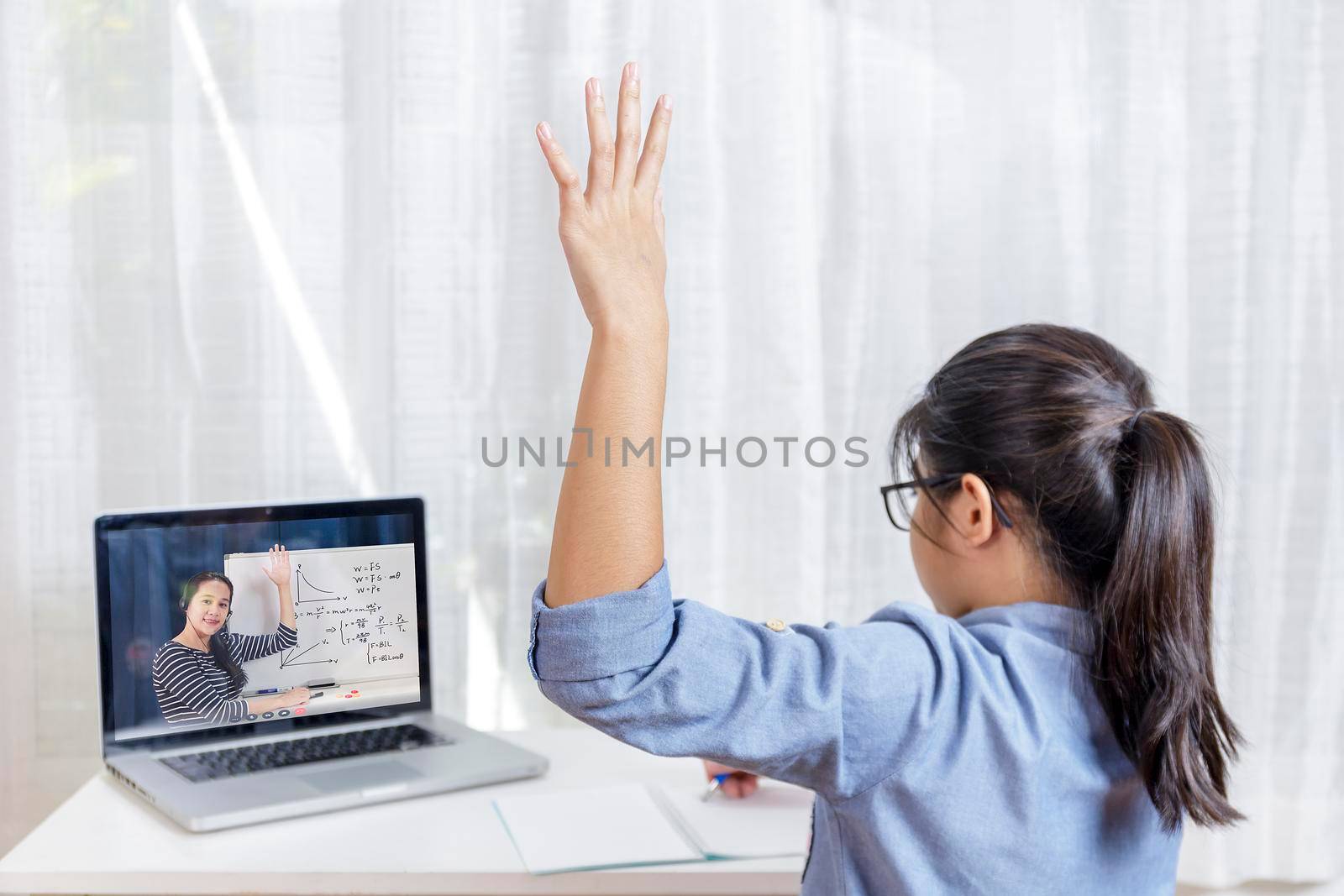 Asian little girl student learning via internet online class from school teacher duling covid-19 outbreak. Man teaching math by whiteboard. Homeschool learn from home concept by Satrinekarn