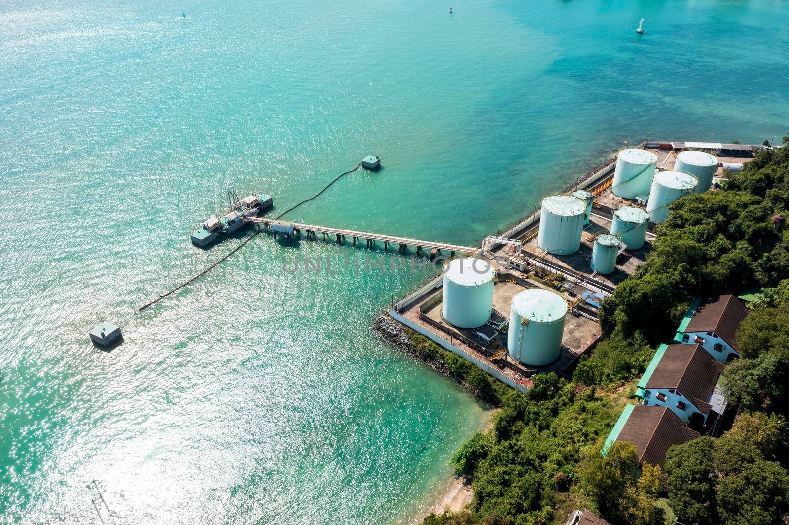 Aerial drone top view of containers cargo ship at industrial import-export port. Business logistic import and export freight transportation by container ship in open sea