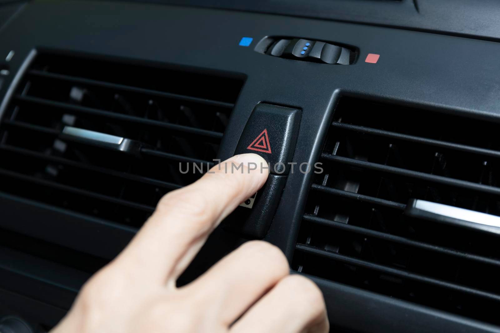 Close up hand press the emergency light in the car, Fingers press button.for open the contract emergency light in car. Emergency button press for open emergency light warning sign symbol out side car