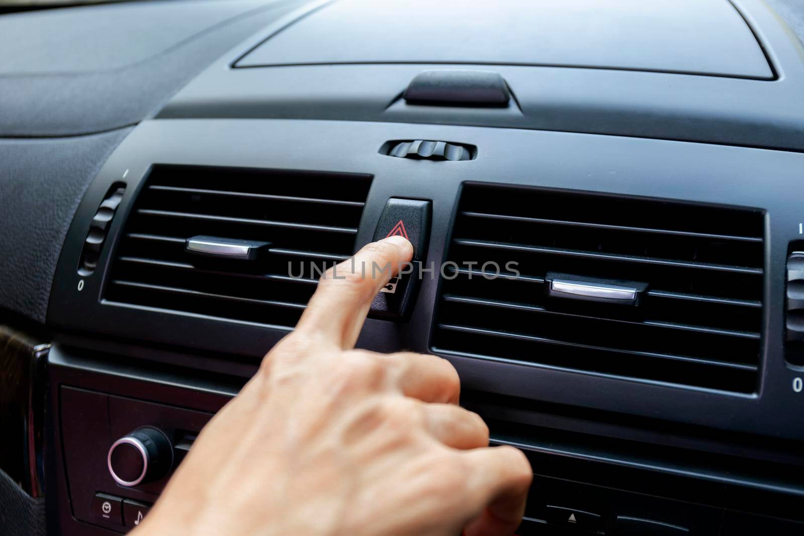 Close up hand press the emergency light in the car, Fingers press button.for open the contract emergency light in car. Emergency button press for open emergency light warning sign symbol out side car