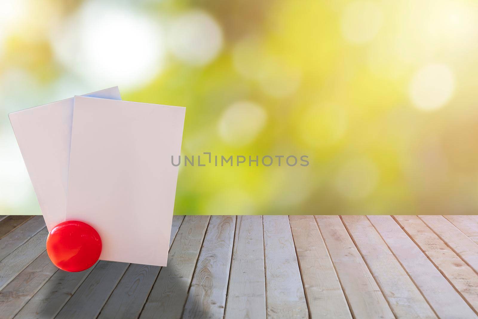 Empty white papers card on wood table with green bokeh background. Empty name card paper on wooden use for text or design. with copy space