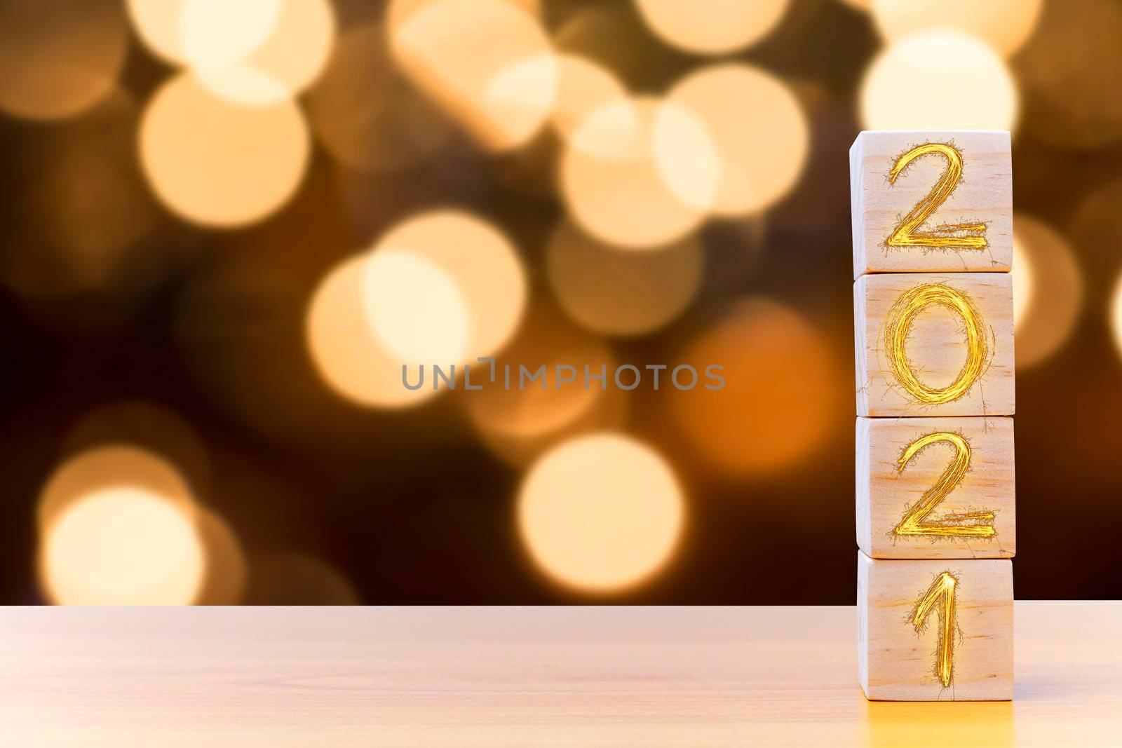 Wooden cubes with 2021 and happy new year with blur bokeh background, banner with copy space. New year greeting card template. 2021 light text on wood block. New year concept.