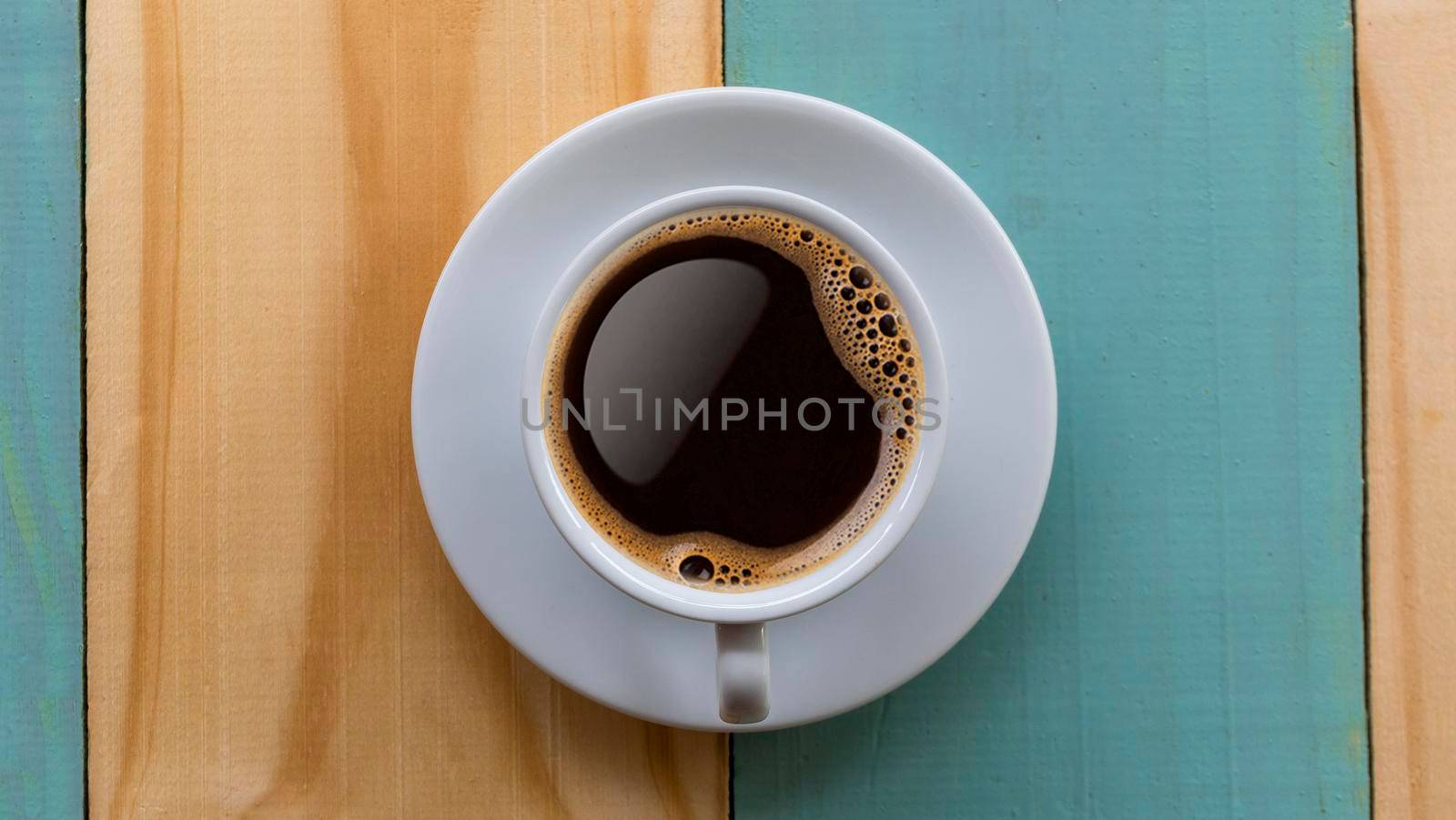 Coffee Mug on Wooden Table. Top view cup of coffee on wooden table. Close up hot coffe in white cup on wood table.
