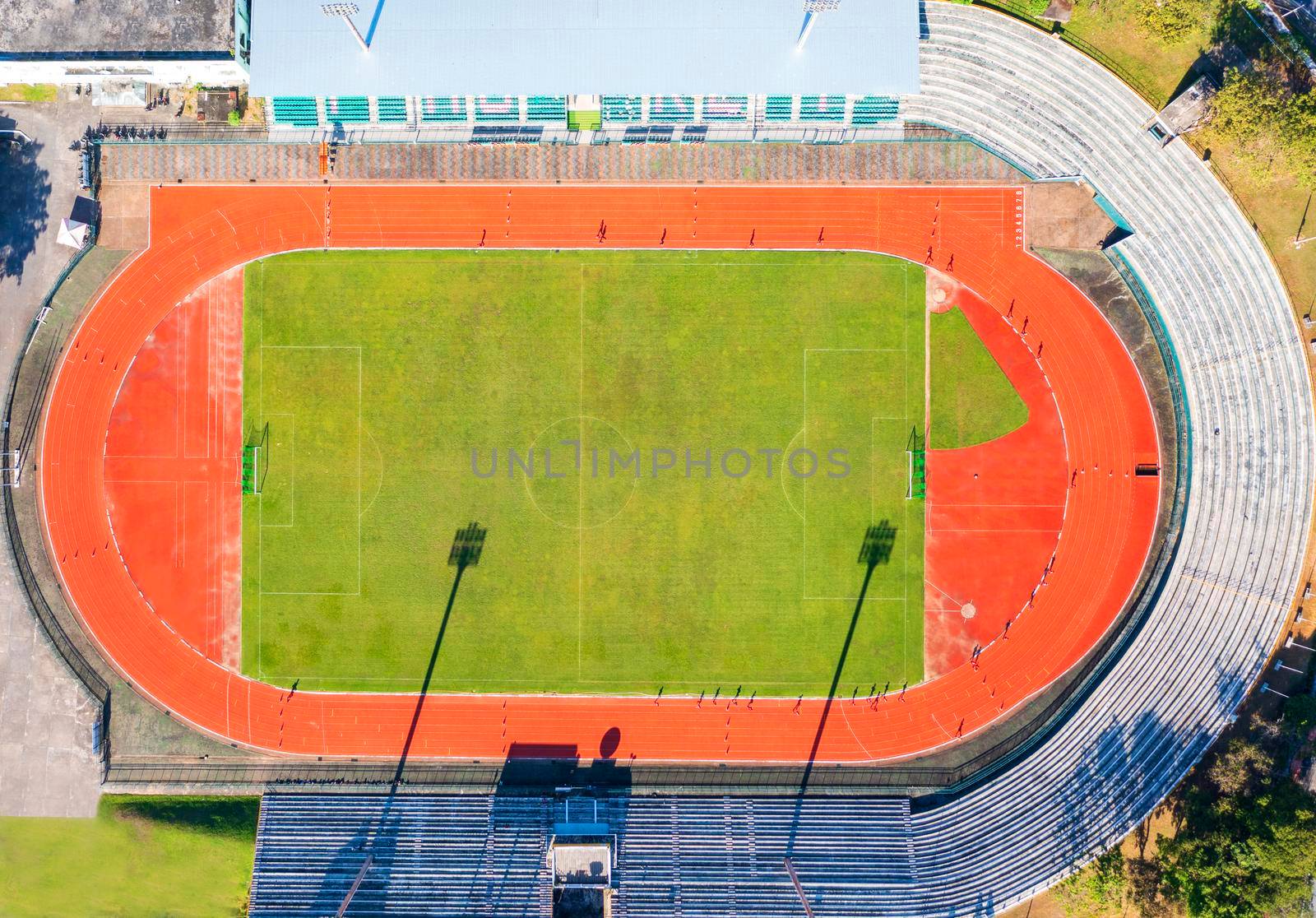 Aerial drone top down view of soccer stadium. Football stadium  with running field  shot with drone at Phuket Thailand by Satrinekarn