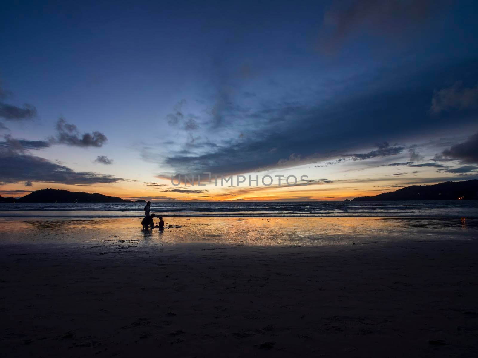 Beautiful sunset over the clam sea with cloud sky background. Sunset over tropical beach. Nature summer  concept. Peak sunset over sea with yellow light reflect on sea water. Tranquil seascape. Horizon over the water.