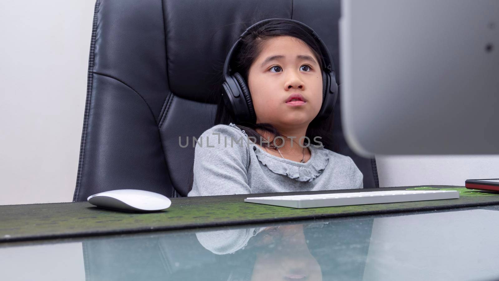 Asian girls study online with laptops. Kid wear headset typing keyboard notebook learning using internet lessons on quarantine. Students learn with internet online class from school Covid-19