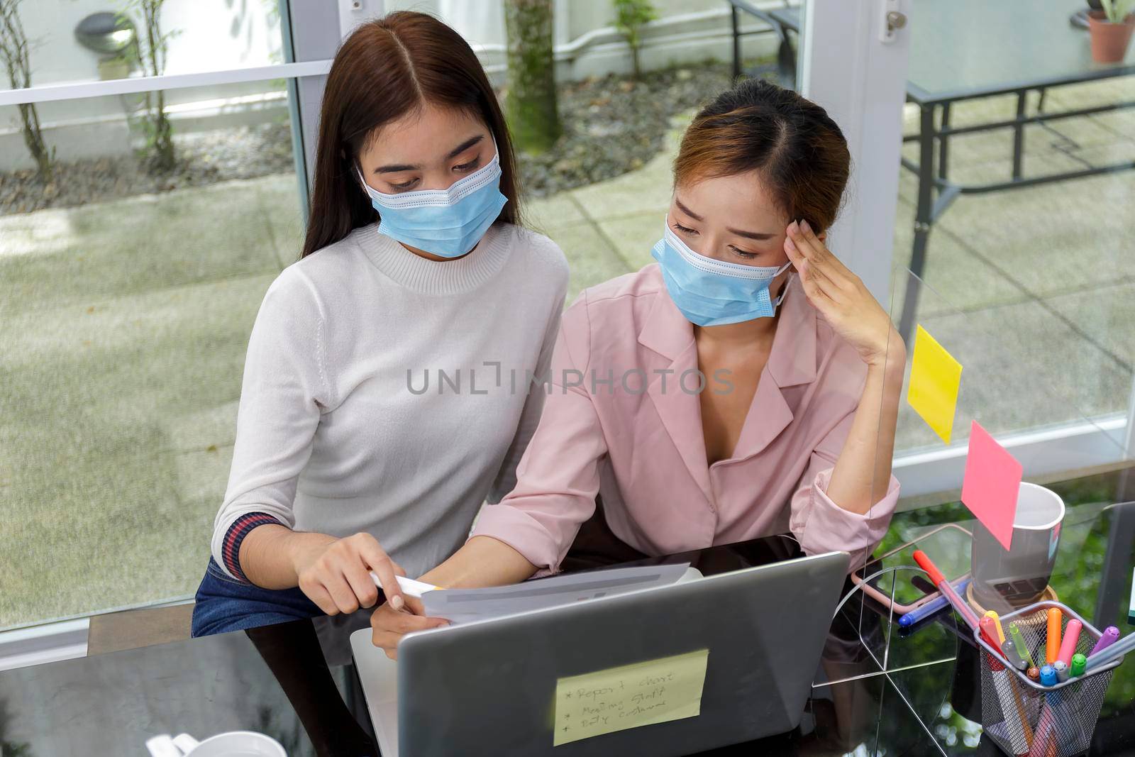 Asian Business Team Meeting Brainstorming Business start up working at Private Home Office social distancing among Coronavirus outbreak New generation business people meeting analysis work from laptop