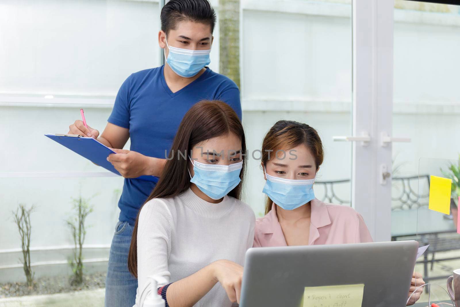 Asian Business Team Meeting Brainstorming Business start up working at Private Home Office social distancing among Coronavirus outbreak New generation business people meeting analysis work from laptop