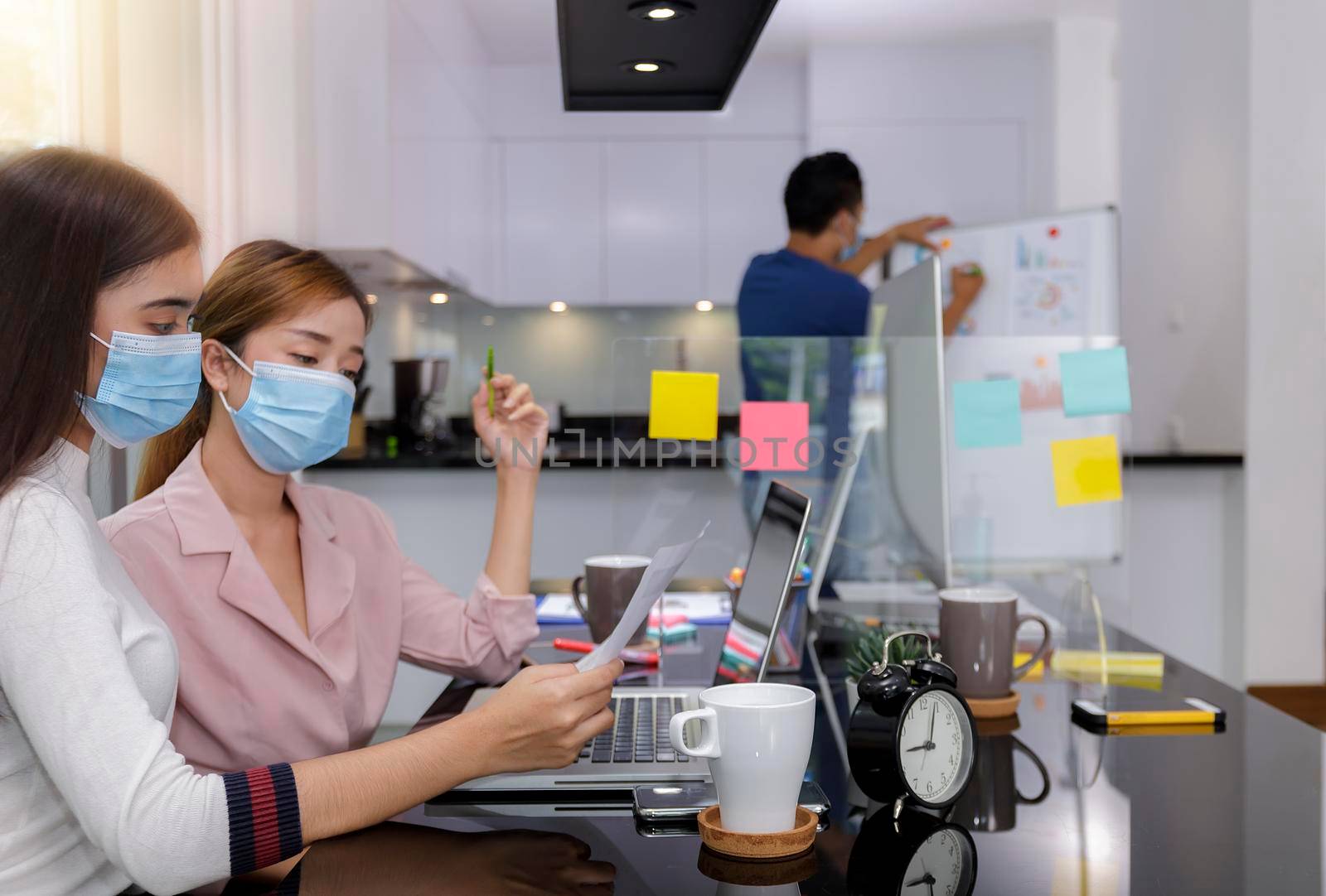 Asian Business Team Meeting Brainstorming Business start up working at Private Home Office social distancing among Coronavirus outbreak New generation business people meeting analysis work from laptop