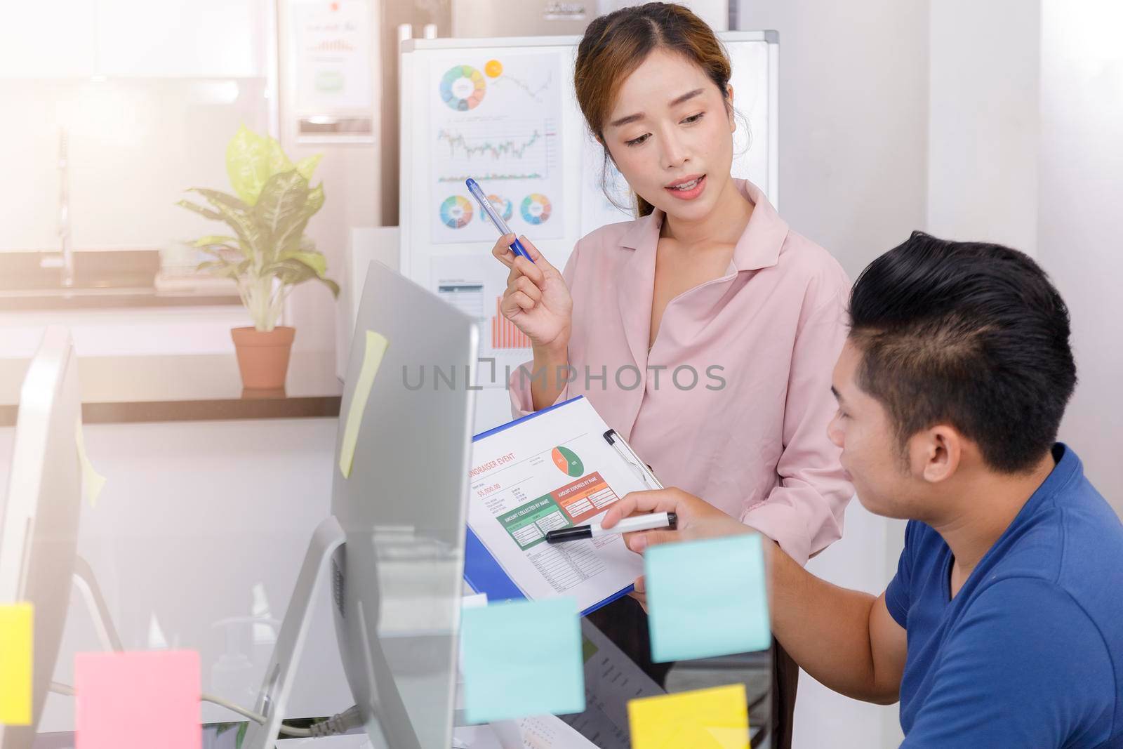 Asian small business start up working at Private Home Office social distancing among Coronavirus outbreak. Business people show and talking about document chart financial report. 