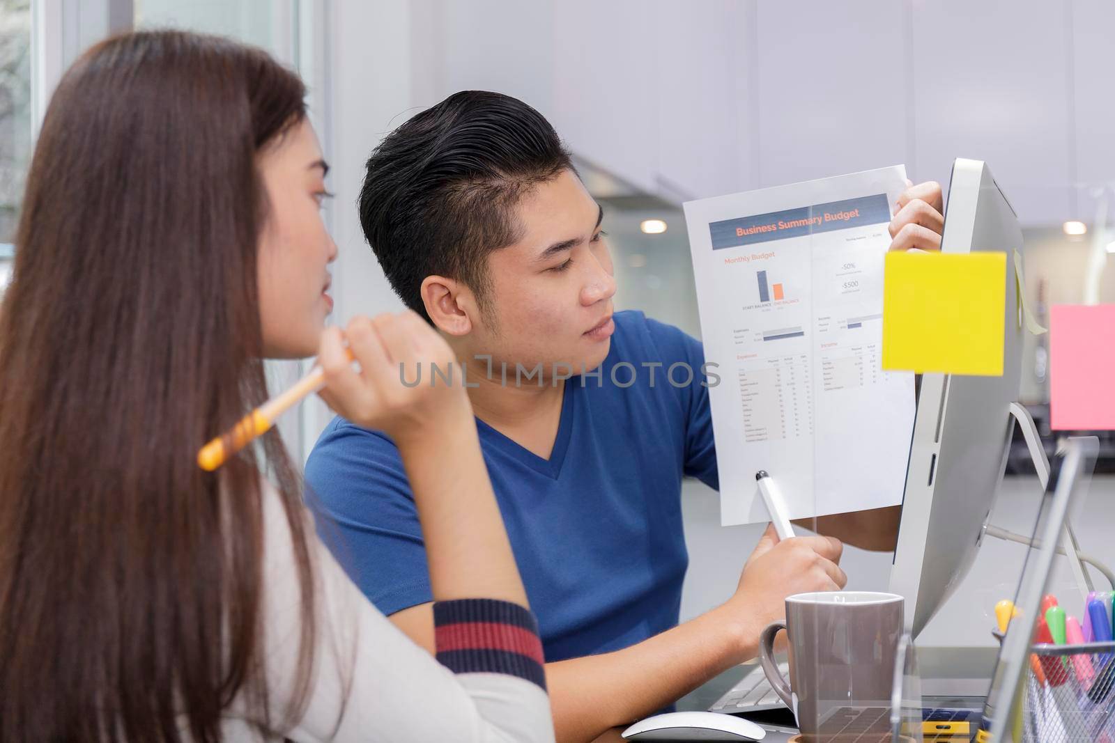 Asian small business startup multiracial working at Private Home Office social distancing among Coronavirus outbreak. Business people show and talking about document chart financial report. 