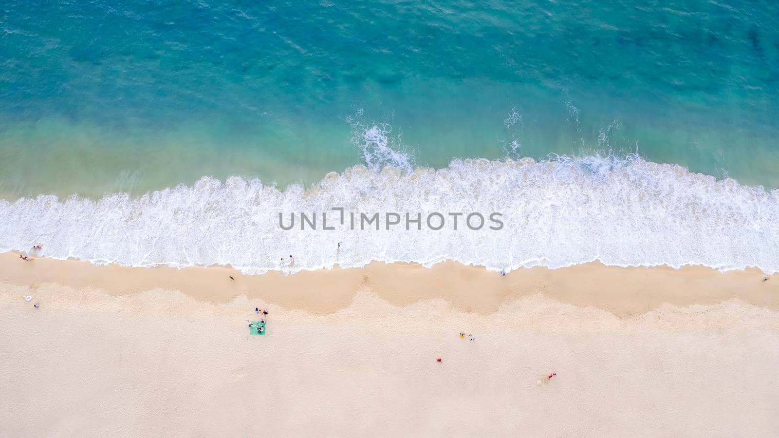  Aerial drone top view crowd of happy people relax at tropical Beach with sunset in Phuket, Thailand, Beautiful Phuket beach is famous tourist destination at Andaman sea. Holiday summer concept