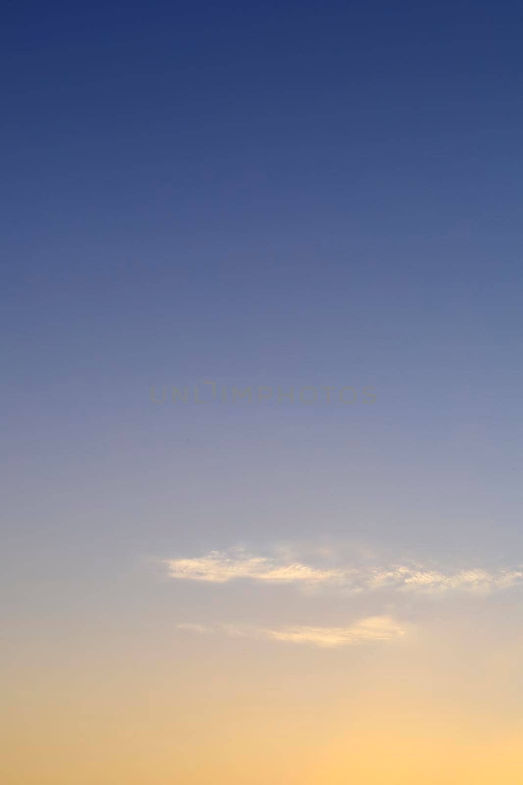 Beautiful morning clear sky background. Colorful yellow blue sky. Morning colorful clear blue sky background with soft white clouds sunrise or sunset.